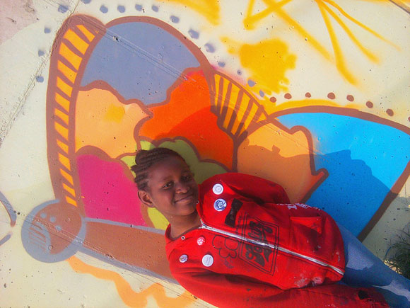 "Young art ambassador" Amani, who lives across the street from Perry Center, poses with her butterfly