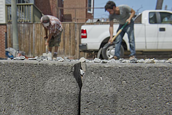 Simmons and employees install permeable pavers to replace a NE D.C. homeowner's previous driveway