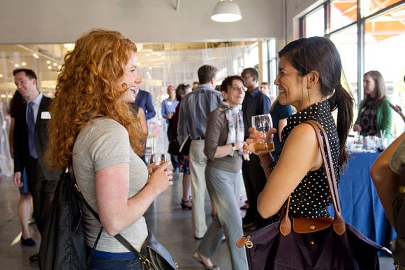 Guests continuing the conversation over drinks and snacks