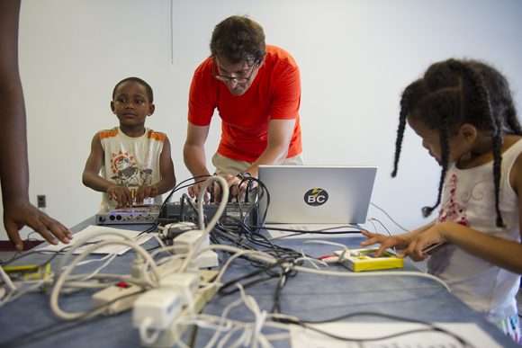 Quincy Almstrom, 7, and others play with the touch-screen synthesizers