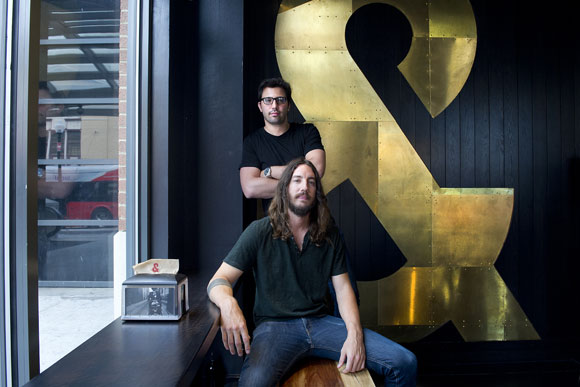 Michael Lastoria (seated) and Steve Salis, co-founders of &pizza, at their U St. location