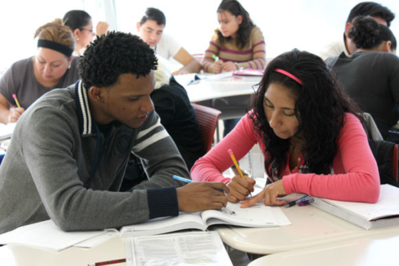Nonprofits are transforming themselves into charter schools, a move that assists with budgeting but can come with tradeoffs. Here, Carlos Rosario adult charter students do an ESL assignment