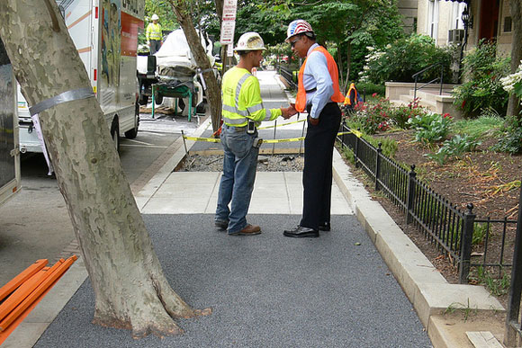 Workers stand on installed Flexi-Pave