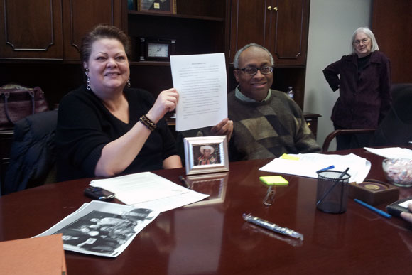 Residents of the 5741 Colorado Ave NW building smile as they close on their building and officially become owners