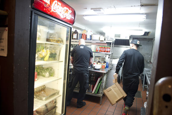 Bourbon managing partner James Woods takes boxes to the trash while Judycki, left, makes a batch of beef jerky. Eric uses the space before the kitchen staff arrives and after they've left. He even has his own set of keys