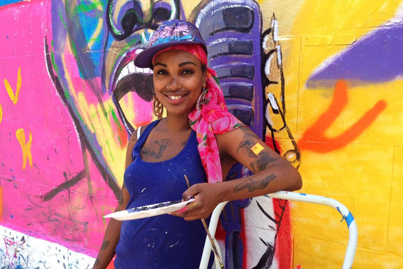 Muralist Zsudayka Nzinga during the first Kennedy Street Sidewalk Festival