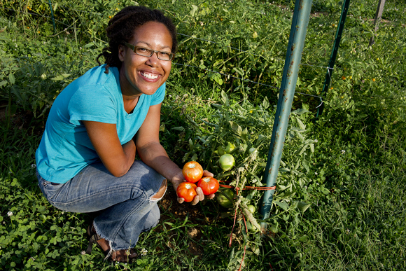 Gail Taylor, who runs the Fourth Street Garden in Brookland near the Basilica of the Shrine of the Immaculate Conception, holds up freshly picked bobcat tomatoes