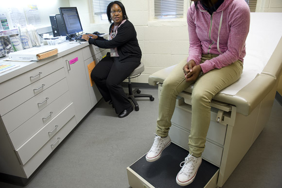 Dr. Lekeisha Terrell, a pediatrician and adolescent medicine specialist, sees a patient at Ballou's student health center, which is one of a handful in DC much more comprehensive than a school nurse's office