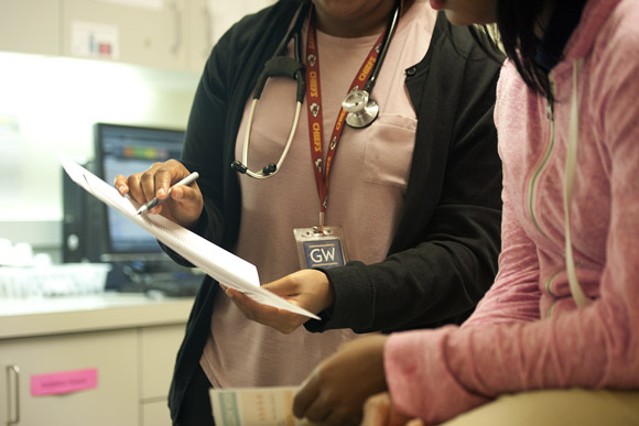 Dr. Lekeisha Terrell goes over birth control options with a student 