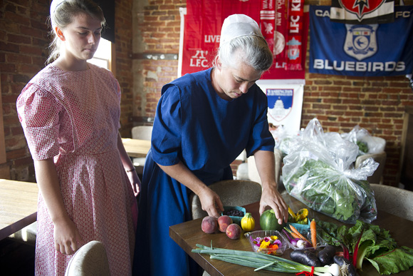 Doreen and Kimberly Shank, who run Hickory Ridge Farm with their family in Franklin County, Penn., unload fresh fruits and veggies at The Queen Vic on H St. NE. The Queen Vic is piloting a "Table to Farm" program 