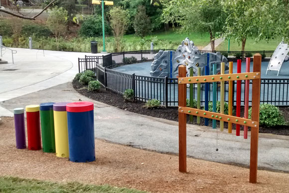 Two of the percussion instruments for kids. The playground in the background is part of Langdon Park