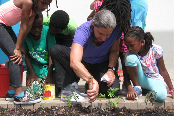 Dance Place founder Carla Perlo digs in the dirt for "Dance Place Garden Club"
