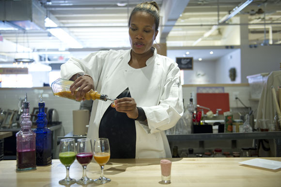 Chef Sonia Adams, owner of Goshen in Union Market, serves samples of her fresh juices. She says her clientele has been becoming more African-American since she opened, and she's not alone: others in D.C. are spreading veganism to people of color