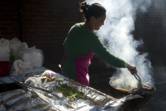 Nancia Sical cooks carne asada and more at the Crossroads Farmer's Market. She is one of a number of women who are hoping to build their small food businesses when Crossroads' new commercial kitchen opens