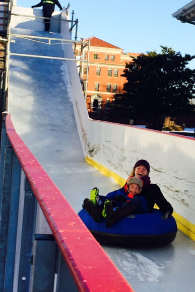 Cherry Tolliver, of Alexandria, and her four-year-old son, ride the slide