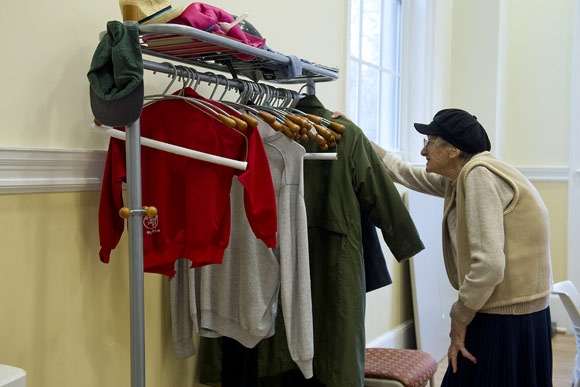 Ninety-two-year-old Irene Stoess hangs up her coat before the Glover Park Senior Village's Conversation Corner, where she can speak her native German with fellow seniors