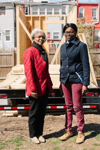 Shelly Karriem, director of the Academy of Construction and Design, and her assistant Krystal Boone, a former student of the program, in front of the Academy's tiny house in Stronghold