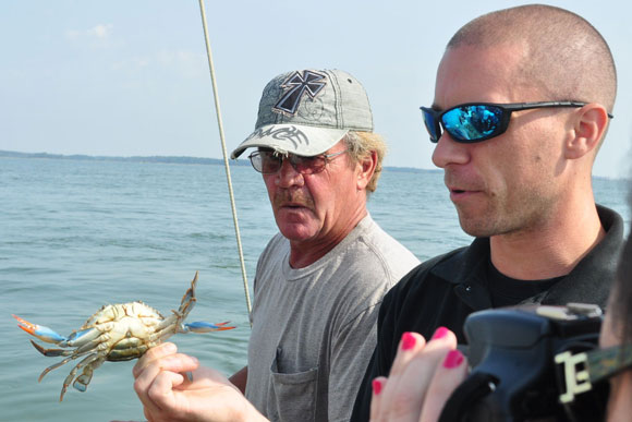 Waterman Ben Parks (left) and Steve Vilnit show off a she-crab's "fingernails"